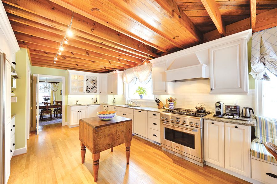 Rustic Farmhouse Kitchen with White Cabinetry and Wine Shelving